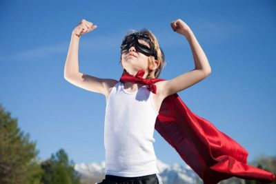 Confident boy with cape