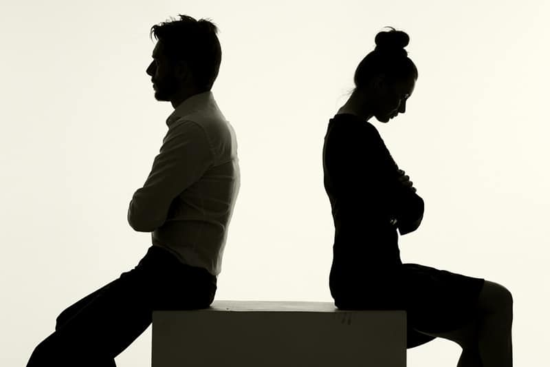 Silhouette of a sad couple arguing
