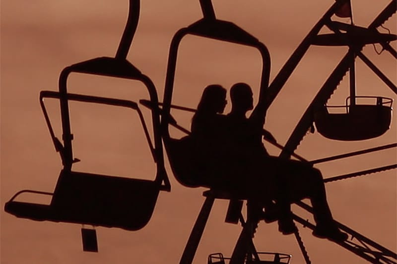 Silhouette of a couple in a cable car