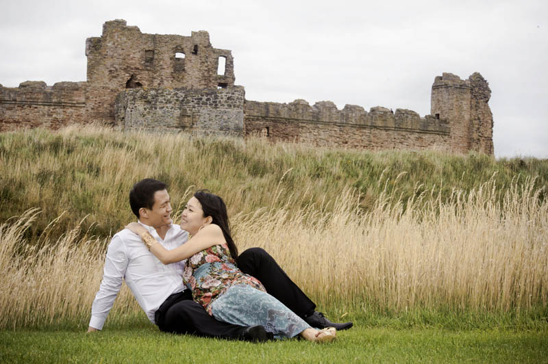 Engagement shoot: Lying at the wheat field outside Tantallon Castle