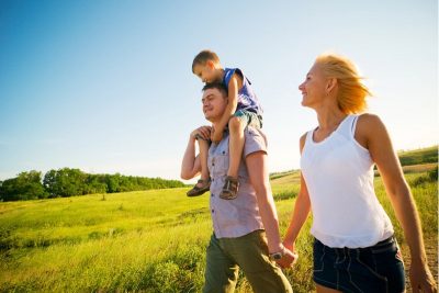 Happy family walking on a field