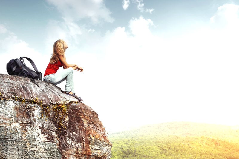 Girl sitting on cliff