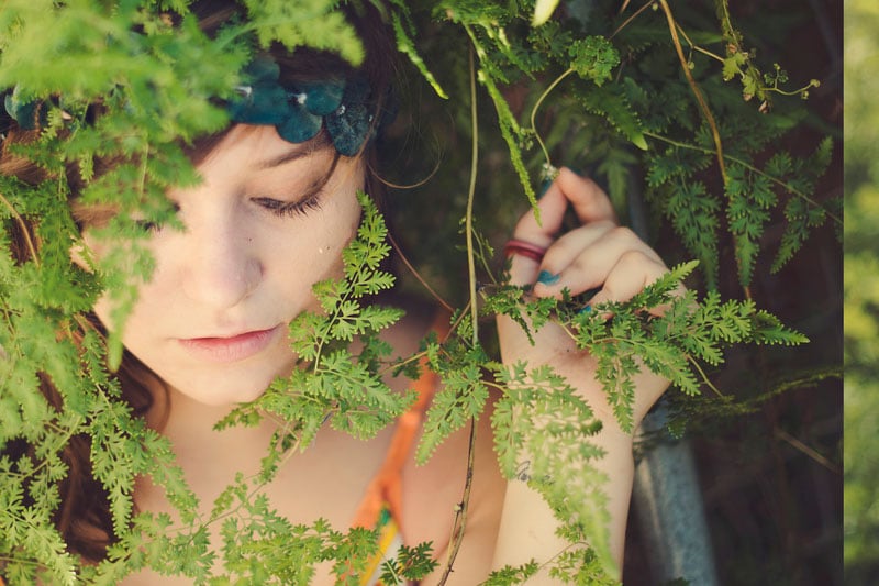Girl behind leaves