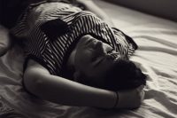 Girl lying on the bed, thinking