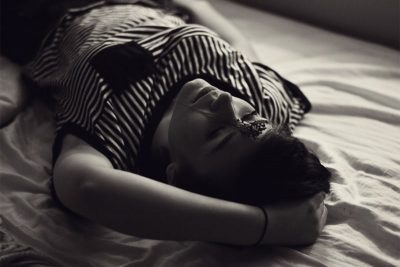 Girl lying on the bed, thinking