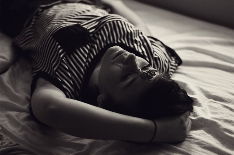 Girl lying on the bed, thinking