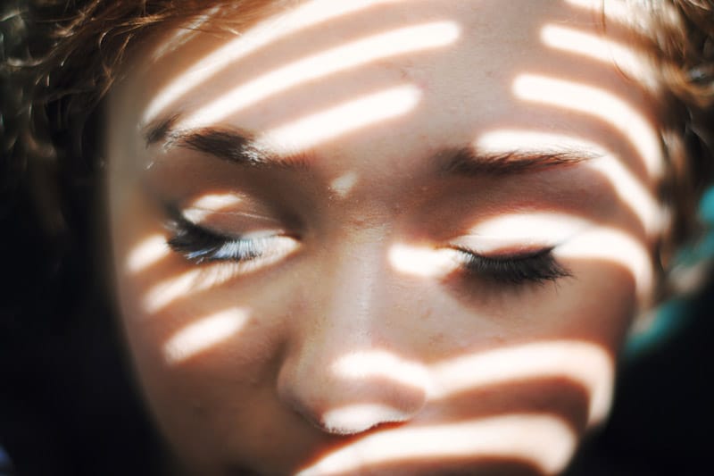 Girl in shadow, with closed eyes
