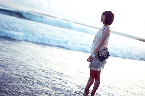 Girl smiling at the shore