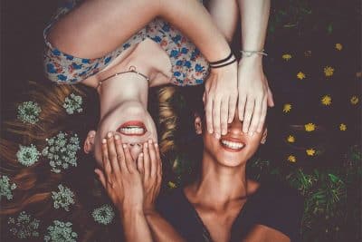 Girls on the field, covering eyes