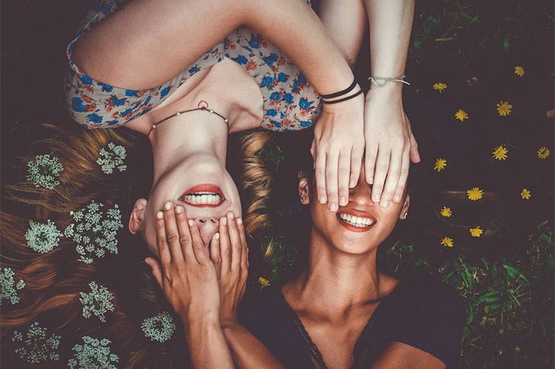 Girls on the field, covering eyes