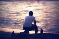 Back view of a guy at the sea