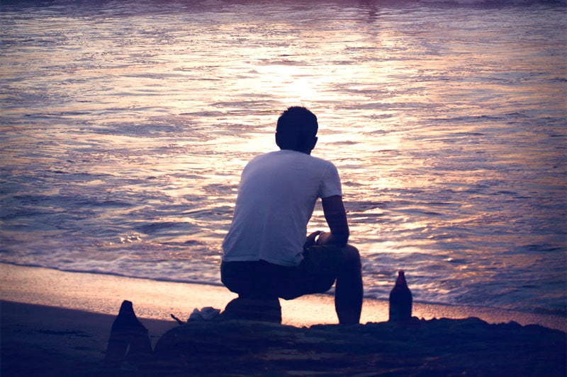 Back view of a guy at the sea