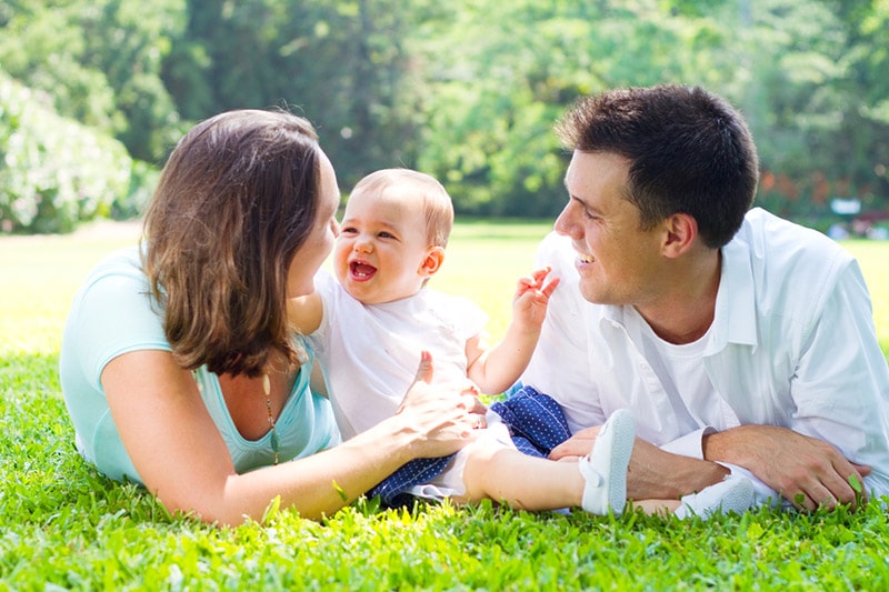 Parents and their baby on the field