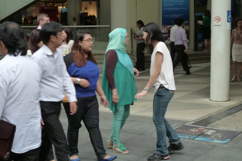 Celes approaching a trio of Malay ladies for a hug