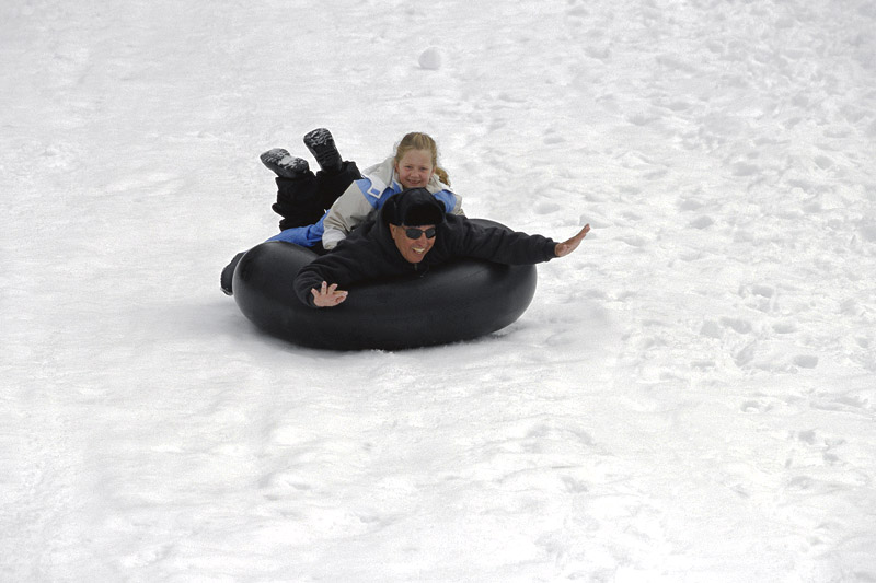 Father and daughter playing on the snow