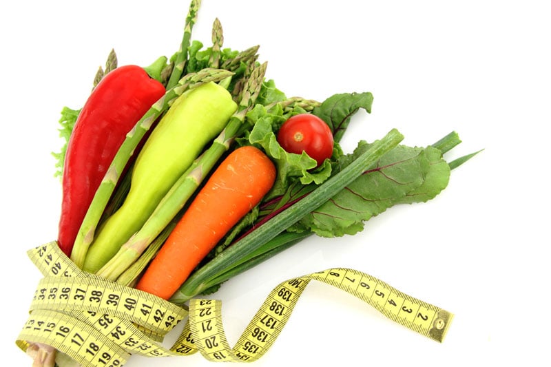 Vegetables wrapped in measuring tape