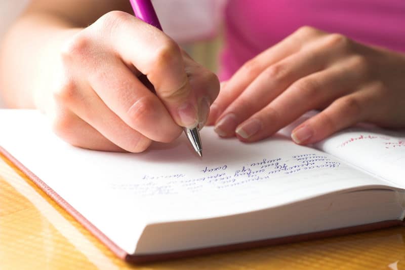 Writing notes in a book